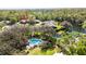 An aerial view showcases the home's proximity to a pool, pond, and surrounding properties at 1025 Royal Troon Ct, Tarpon Springs, FL 34688