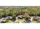 An aerial view highlights the home's location on a cul-de-sac surrounded by trees at 1025 Royal Troon Ct, Tarpon Springs, FL 34688