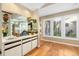 Home wet bar features glass shelves, custom cabinets, and a sink at 1025 Royal Troon Ct, Tarpon Springs, FL 34688