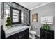Modern bathroom with marble countertop, decorative backsplash, artwork and a beautiful mirror at 1025 Royal Troon Ct, Tarpon Springs, FL 34688