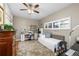 Cozy bedroom featuring a daybed, a sewing machine, a ceiling fan and a large window at 1025 Royal Troon Ct, Tarpon Springs, FL 34688