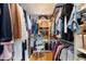 Walk-in closet with built-in shelving, hanging rods, a seat and organized storage solutions at 1025 Royal Troon Ct, Tarpon Springs, FL 34688
