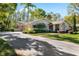 Beautiful single-story home with a well-maintained front yard and a three car garage at 1025 Royal Troon Ct, Tarpon Springs, FL 34688
