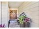 Inviting front entrance with double doors, decorative plants and a brick walkway at 1025 Royal Troon Ct, Tarpon Springs, FL 34688