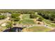 Aerial view showcasing the meticulously maintained golf course with mature trees and lush greenery at 1025 Royal Troon Ct, Tarpon Springs, FL 34688
