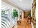 Bright hallway with hardwood floors, plantation shutters, and natural light at 1025 Royal Troon Ct, Tarpon Springs, FL 34688