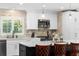 Bright kitchen featuring white cabinetry, stainless steel appliances, and light stone backsplash at 1025 Royal Troon Ct, Tarpon Springs, FL 34688