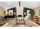 Living room with stone fireplace, tall ceilings, and abundant natural light at 1025 Royal Troon Ct, Tarpon Springs, FL 34688