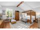 Bright main bedroom with a vaulted ceiling, wood beam, and plantation shutters at 1025 Royal Troon Ct, Tarpon Springs, FL 34688