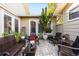 Charming brick patio with comfortable seating, plants and a tree for relaxing and entertaining outdoors at 1025 Royal Troon Ct, Tarpon Springs, FL 34688