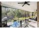 Screened in patio with outdoor seating and a view of the backyard at 1025 Royal Troon Ct, Tarpon Springs, FL 34688