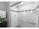 Clean, bright shower with white subway tile, glass door and modern showerhead at 1025 Royal Troon Ct, Tarpon Springs, FL 34688