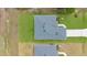 An elevated view shows the roof design, new landscaping, and large lawn at 488 Sunset N Rd, Rotonda West, FL 33947