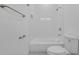 Bright white bathroom featuring a tiled shower, tub and a toilet at 488 Sunset N Rd, Rotonda West, FL 33947