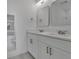 Contemporary bathroom with dual sinks, large mirrors, and modern white cabinetry at 488 Sunset N Rd, Rotonda West, FL 33947