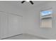 Bright bedroom with white closet doors, window and tiled flooring at 488 Sunset N Rd, Rotonda West, FL 33947