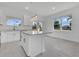 Bright kitchen features an island with light countertops, white cabinets, and stainless steel faucet at 488 Sunset N Rd, Rotonda West, FL 33947