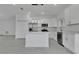 Bright, open kitchen with stainless steel appliances, white cabinetry, quartz countertops, and tile flooring at 488 Sunset N Rd, Rotonda West, FL 33947