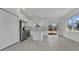 Bright kitchen featuring stainless steel appliances, white cabinets, island, and sliding glass doors to the backyard at 488 Sunset N Rd, Rotonda West, FL 33947