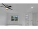 Bright living room with neutral walls, ceiling fan, and access to the outdoors at 488 Sunset N Rd, Rotonda West, FL 33947