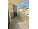 A sunny balcony with tile floors and views of the community pool area at 6009 Sea Ranch Dr # 101, Hudson, FL 34667