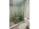 Bathroom features a glass shower with tiled walls and a dual flush toilet at 6009 Sea Ranch Dr # 101, Hudson, FL 34667