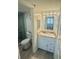 Bathroom featuring a granite countertop, vanity, and a glass shower enclosure at 6009 Sea Ranch Dr # 101, Hudson, FL 34667