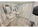 Shared bathroom with two sinks with mirrors, tiled walls, tile flooring and a trash can at 6009 Sea Ranch Dr # 101, Hudson, FL 34667