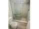 Bathroom features a glass shower with tiled walls and a dual flush toilet at 6009 Sea Ranch Dr # 101, Hudson, FL 34667