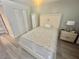 Well-lit bedroom boasts a modern bed, matching nightstand, and ample closet space at 6009 Sea Ranch Dr # 101, Hudson, FL 34667