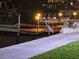 Waterfront property featuring private dock, boat and night lighting, perfect for evening relaxation and enjoying water views at 6009 Sea Ranch Dr # 101, Hudson, FL 34667