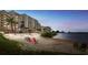 Beachfront condo with shoreline and colorful seating at 6009 Sea Ranch Dr # 101, Hudson, FL 34667