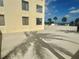 A sunny exterior view of the building with community pool and deck at 6009 Sea Ranch Dr # 101, Hudson, FL 34667