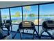 Treadmills in the community fitness center with large picture window and serene water views at 6009 Sea Ranch Dr # 101, Hudson, FL 34667