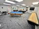 Spacious game room with a pool table, shuffleboard, and other games, perfect for entertainment and recreation at 6009 Sea Ranch Dr # 101, Hudson, FL 34667
