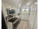 Modern kitchen features stainless steel appliances, granite countertops, and ample cabinet space at 6009 Sea Ranch Dr # 101, Hudson, FL 34667