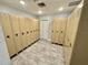 Locker room with two rows of lockers and wood-look tile flooring for storage and convenience at 6009 Sea Ranch Dr # 101, Hudson, FL 34667