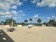 Community pool deck features lounge chairs and dining tables with beautiful blue sky views at 6009 Sea Ranch Dr # 101, Hudson, FL 34667