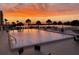 Inviting pool area with lounge chairs, tables, and scenic waterfront views at sunset at 6009 Sea Ranch Dr # 101, Hudson, FL 34667
