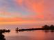 Vibrant sunset over the calm water, providing a stunning backdrop for this coastal property at 6009 Sea Ranch Dr # 101, Hudson, FL 34667