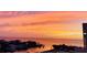 Scenic sunset view over bay and waterfront homes, showing sky with hues of orange and yellow at 6009 Sea Ranch Dr # 101, Hudson, FL 34667