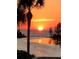 Scenic sunset view overlooking ocean waters with palm trees silhouetted in the foreground at 6009 Sea Ranch Dr # 101, Hudson, FL 34667