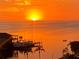 Spectacular water view featuring a vibrant sunset, private dock, and serene atmosphere at 6009 Sea Ranch Dr # 101, Hudson, FL 34667