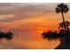 Tranquil waterfront view at sunset with boats docked and palm trees silhouetted at 6009 Sea Ranch Dr # 101, Hudson, FL 34667