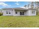 Home exterior with well-maintained backyard, covered patio, and sliding glass doors at 4160 Belladonna Ave, North Port, FL 34286