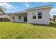 Home exterior with well-maintained backyard, covered patio, and sliding glass doors at 4160 Belladonna Ave, North Port, FL 34286