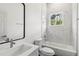 Bright bathroom with tub and shower combination and marble tiling at 4160 Belladonna Ave, North Port, FL 34286