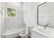 Modern bathroom with tub and shower combination and marble tiling at 4160 Belladonna Ave, North Port, FL 34286