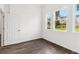 Bright bedroom with three windows showing the outside scenery and a doorway at 4160 Belladonna Ave, North Port, FL 34286