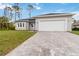 Charming single-story home with a two-car garage, landscaped yard and brick paver driveway at 4160 Belladonna Ave, North Port, FL 34286